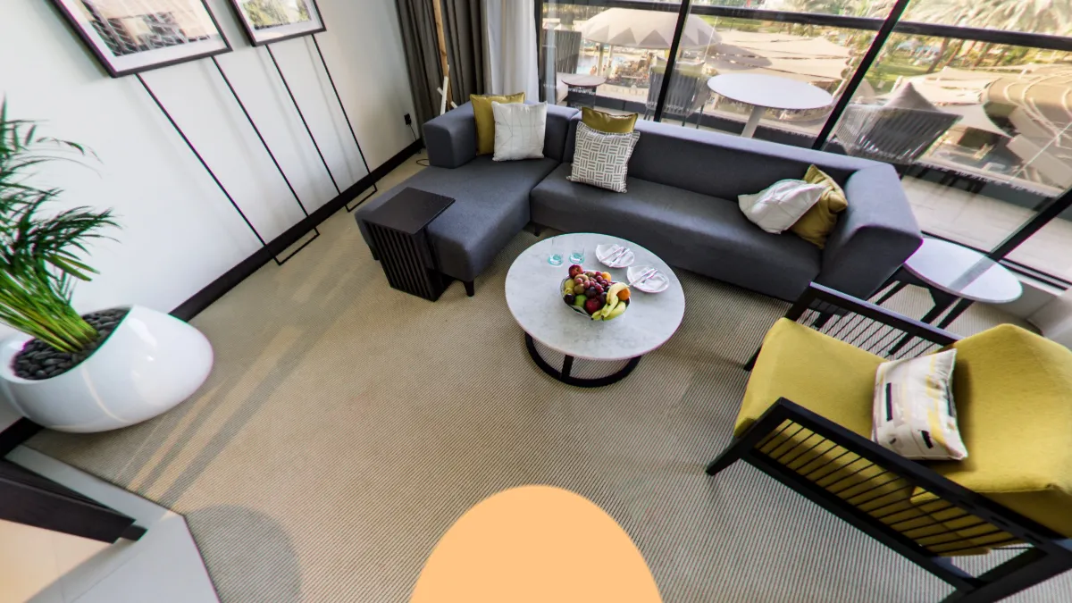 The same lounge in a hosted tour: the venue's own logo on the round patch over the tripod